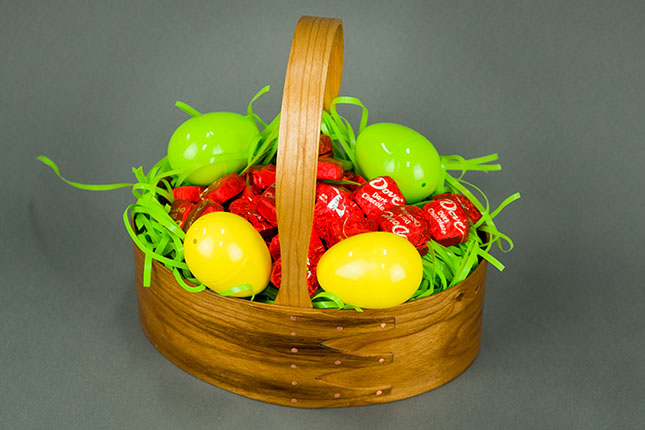 Shaker bentwood oval carrier holding dark chocolates for Easter