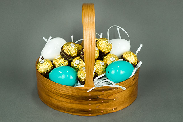 Shaker oval handled carrier containing chocolate truffles